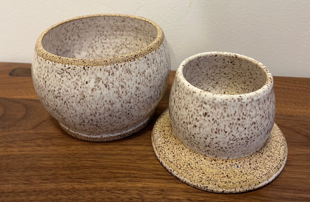Ceramic butter dish set with two cream speckled cups and bases, textured glaze
