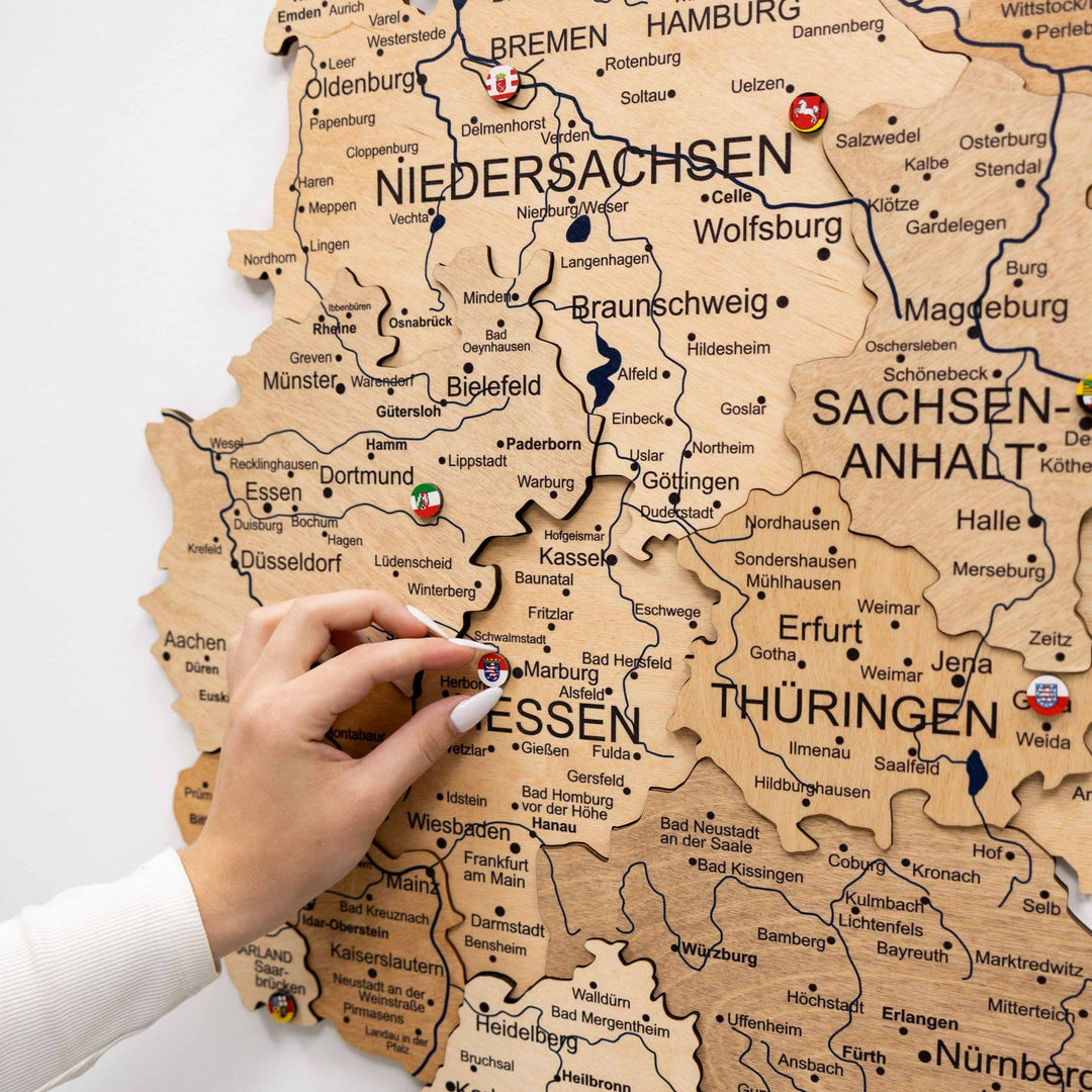 3D wooden Germany map with raised borders and labeled federal states, close-up