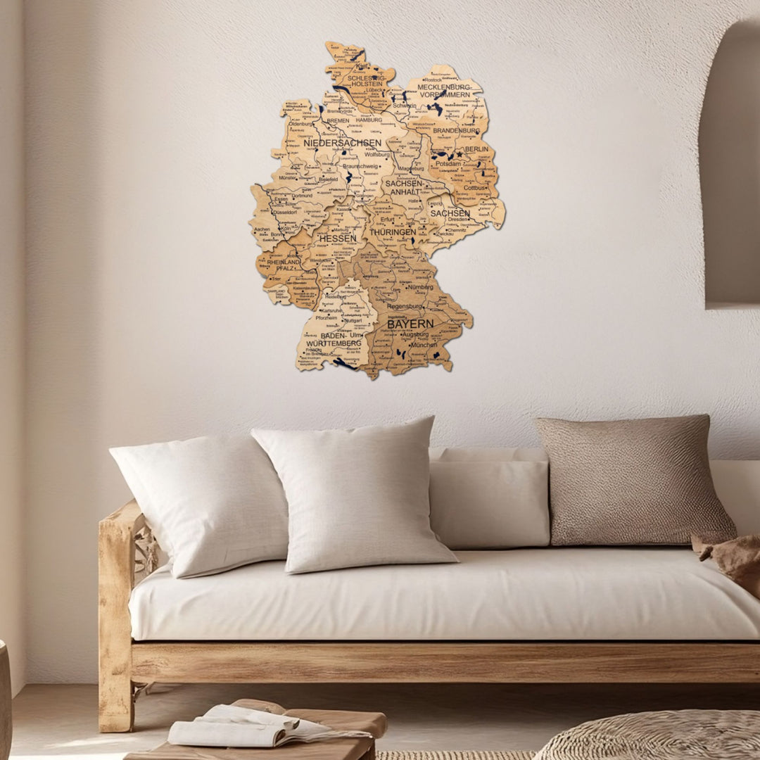 3D wooden Germany wall map mounted above a sofa in a living room