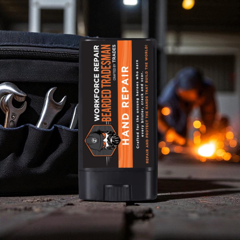 Black hand repair balm tube with orange WORKFORCE label on work surface