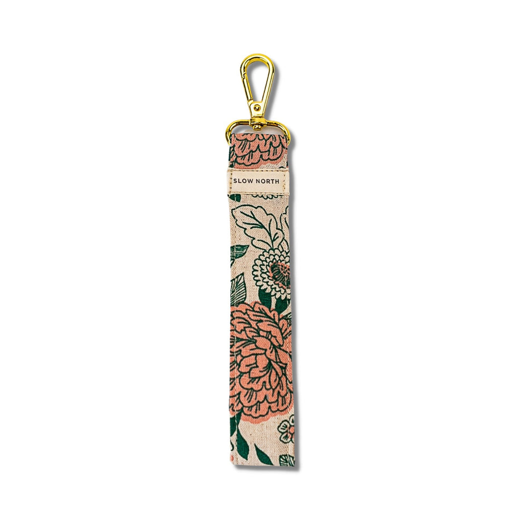 Tall beige floral wristlet keychain with gold carabiner and strap