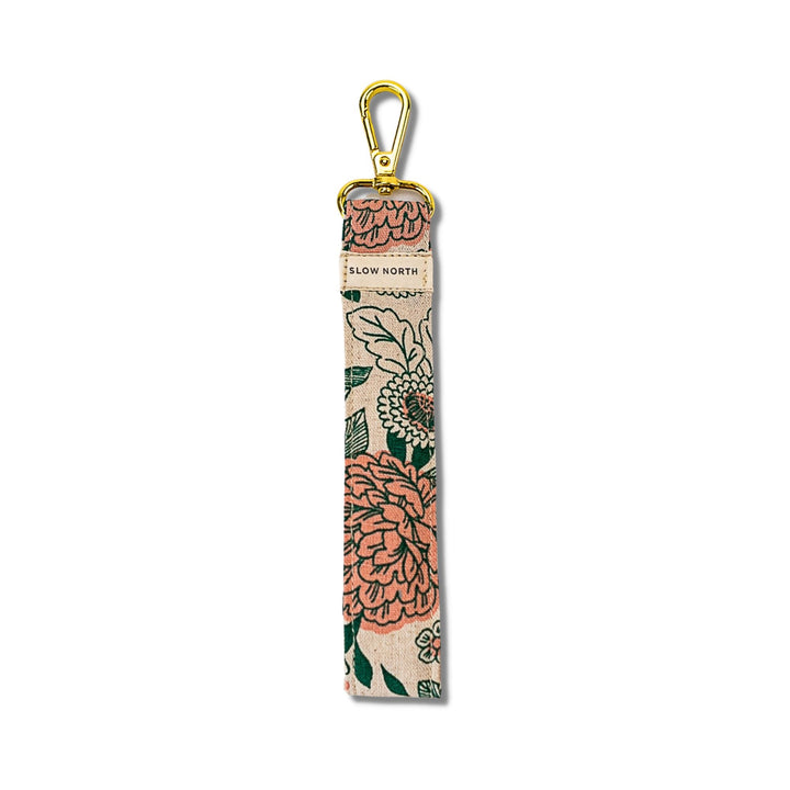 Tall beige floral wristlet keychain with gold carabiner and strap