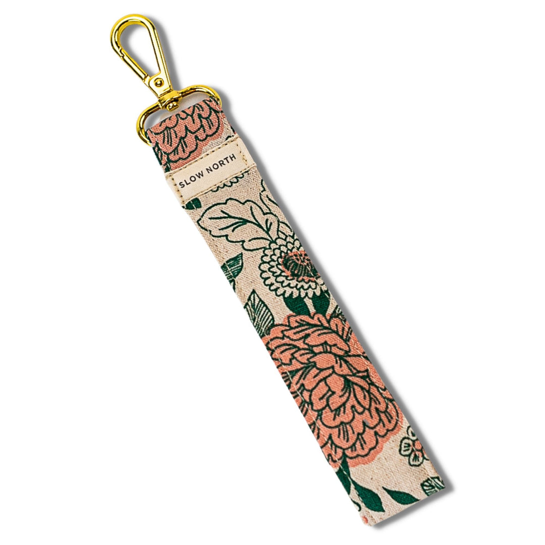 Beige floral wristlet keychain with gold carabiner and fabric strap
