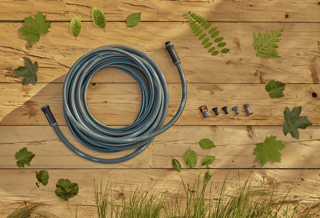 Garden hose coil with blue stripes and included hose fittings on a wooden surface