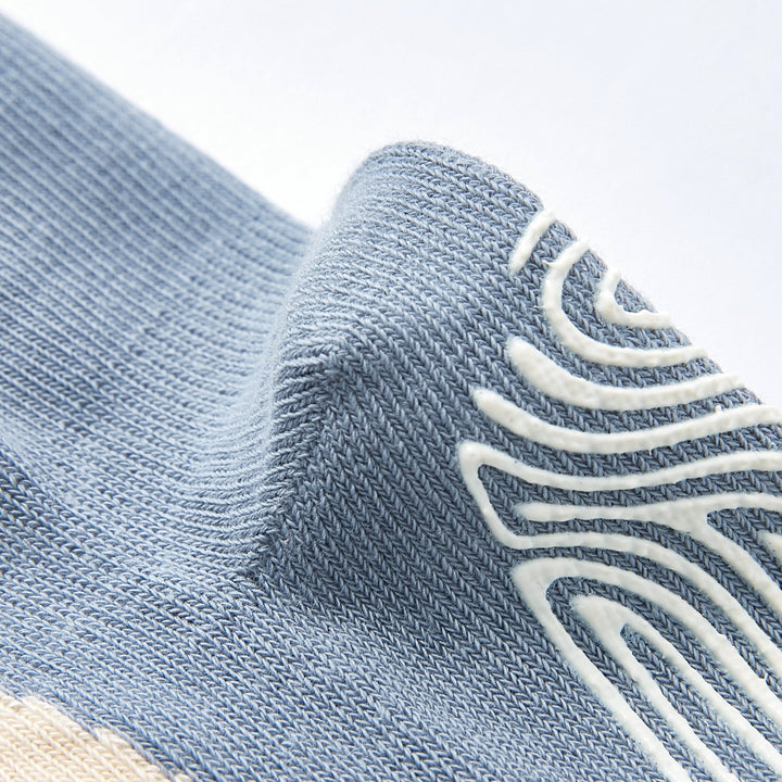 Light blue crew sock knit close-up with outlined non-slip grip pattern