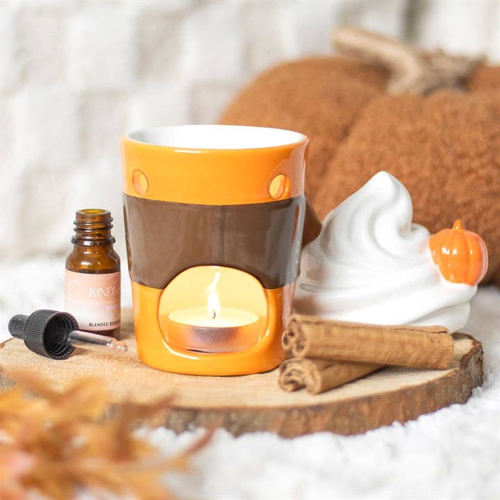 Lidded oil burner wax warmer: orange and brown cup with white lid, lit candle