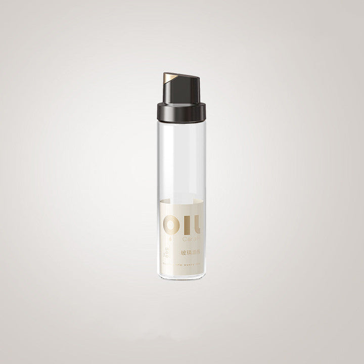 Clear glass oil dispenser bottle with black cap