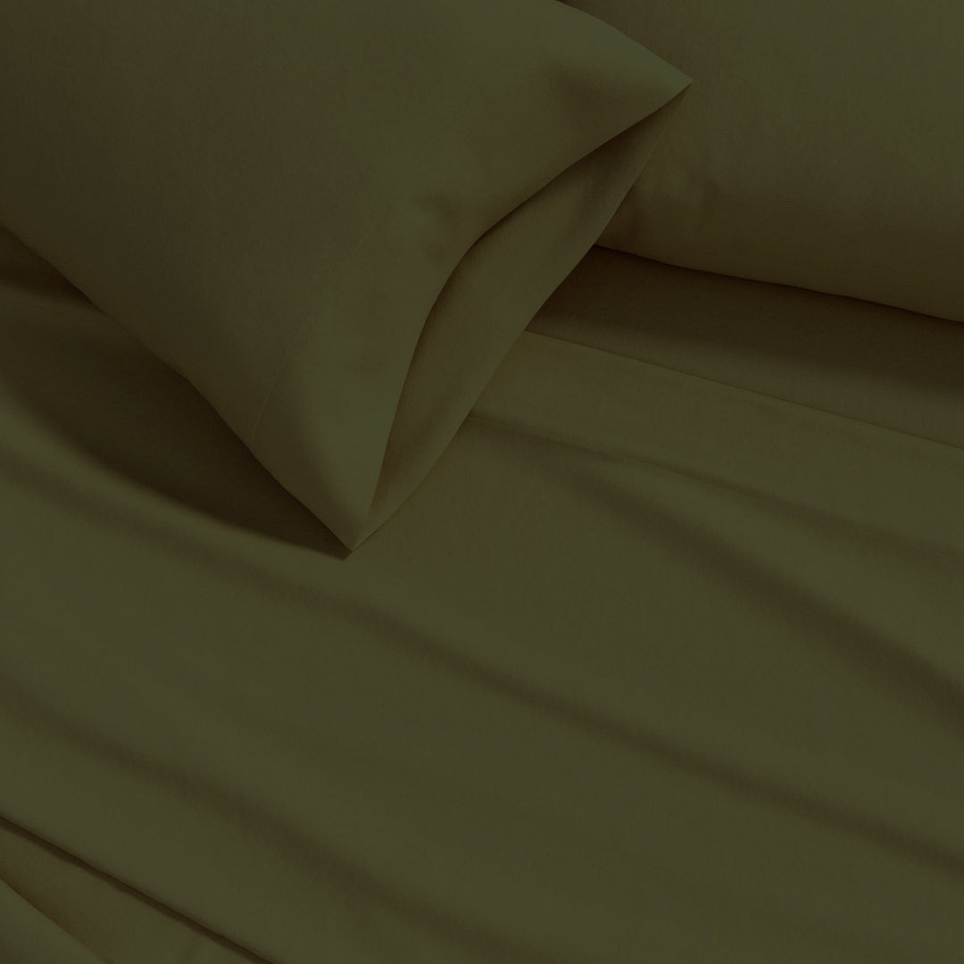 Cotton flannel sheet close-up in olive green, soft solid fabric folds