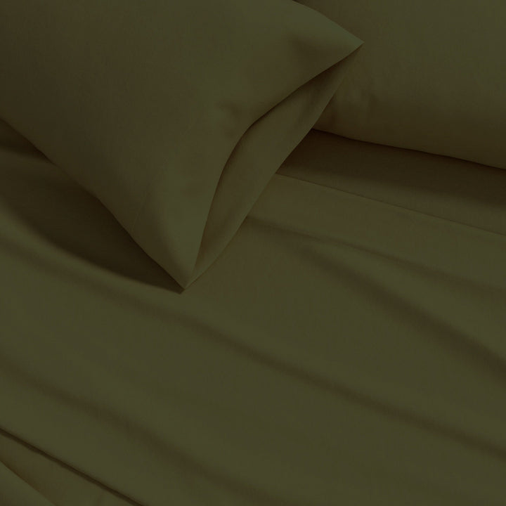 Cotton flannel sheet close-up in olive green, soft solid fabric folds