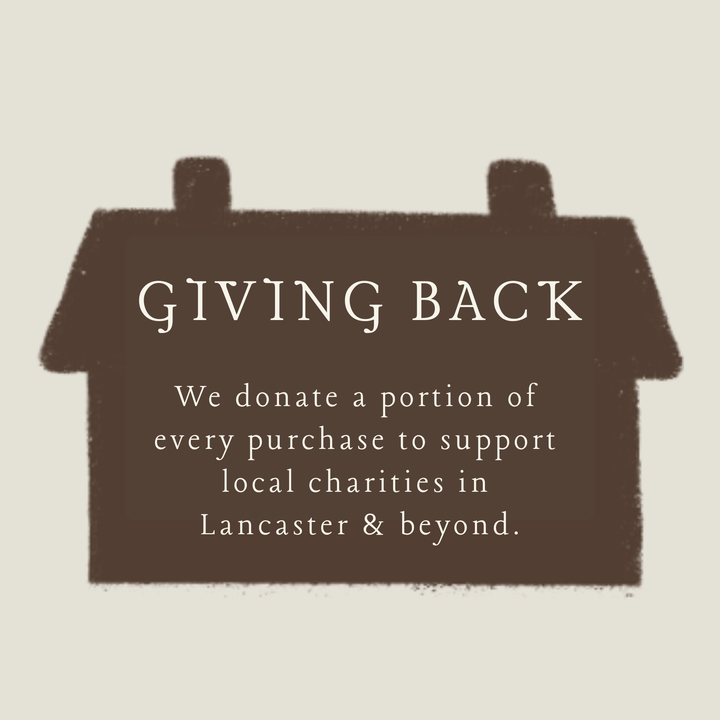 Giving Back donation message on a brown house-shaped sign