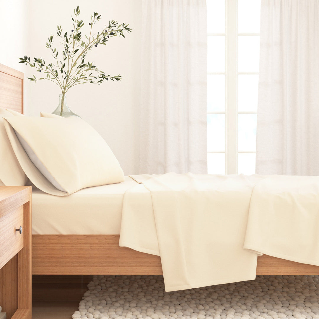 Pristine ivory cotton flannel sheet on bed with matching pillowcase