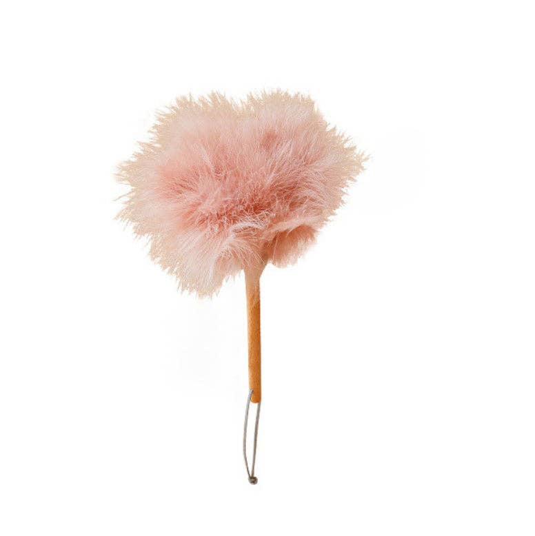 Pink feather duster with round, fluffy ostrich plume head on wooden stick handle