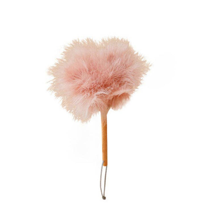 Pink feather duster with round, fluffy ostrich plume head on wooden stick handle