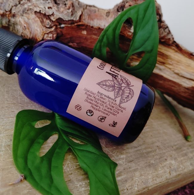 Blue after shave mist spray bottle with ingredient panel label and spray top