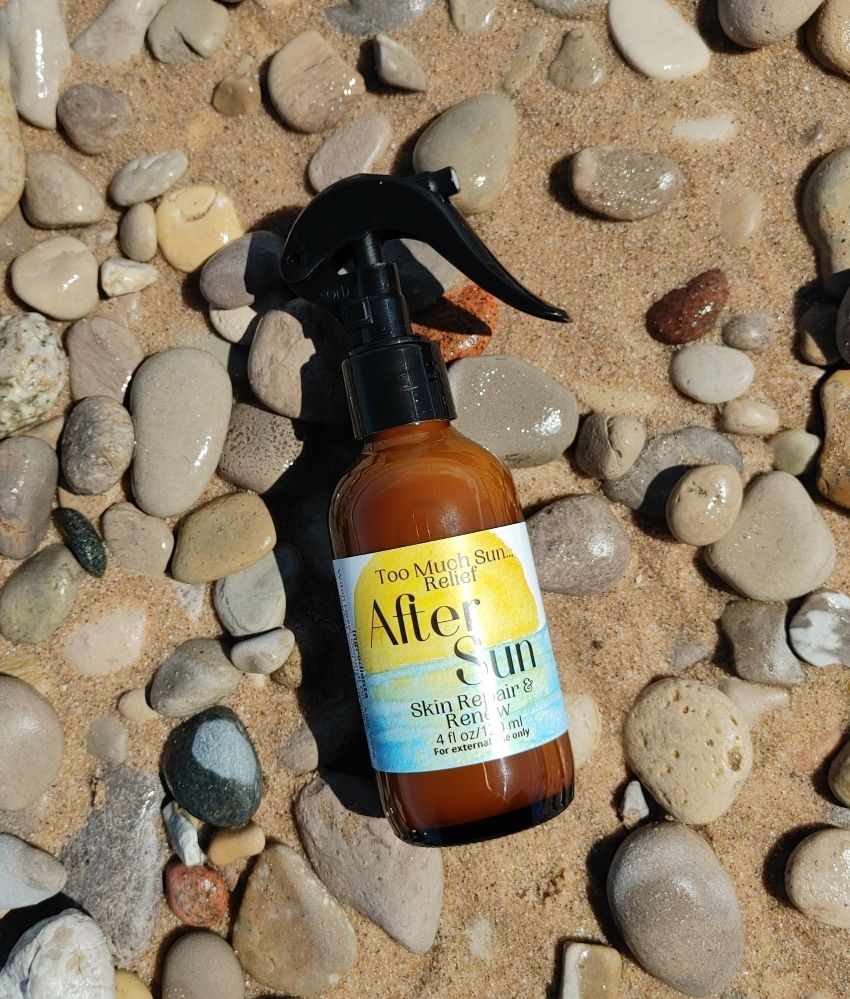 After sun skin relief spray bottle with black pump, amber liquid close-up.