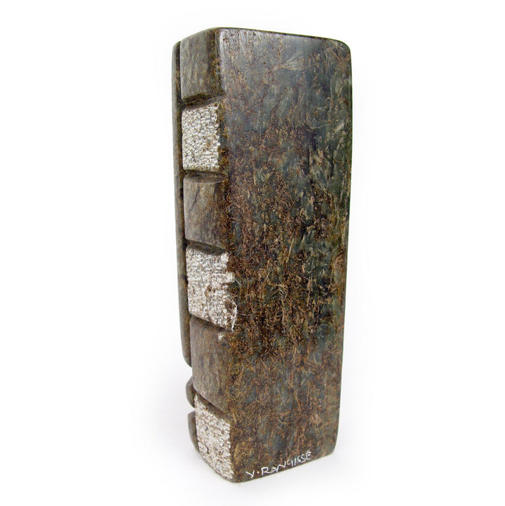 Abstract stone sculpture side profile with brown-green texture and white block inlays