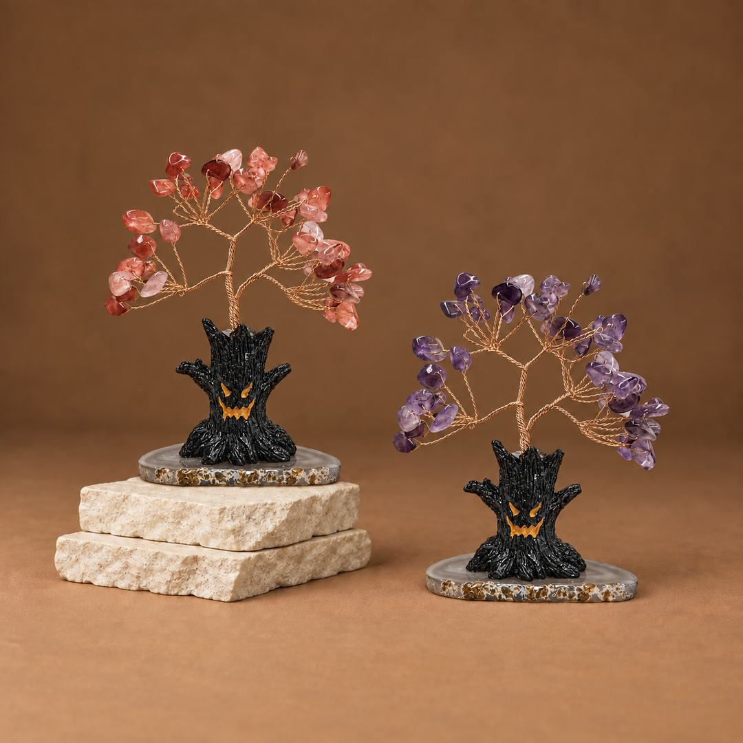 Halloween crystal tree sculpture with pink and purple gemstone branches on black base