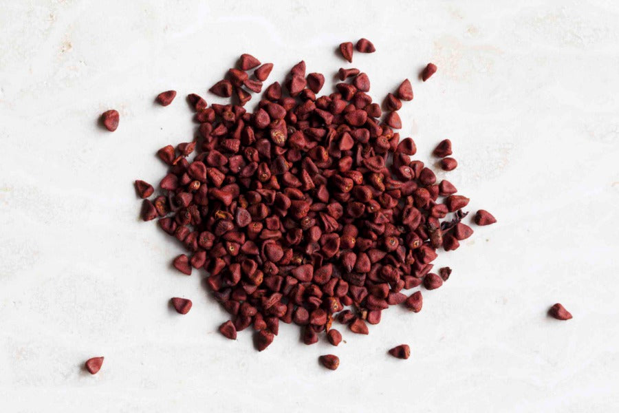 Whole annatto seeds, small dark-red dried seeds