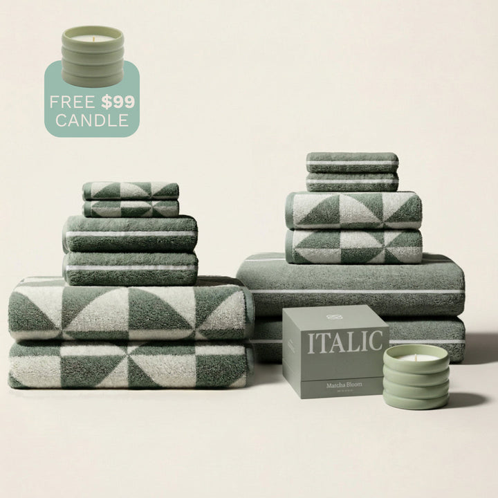 Green cotton towel set with ecru and green patterned bands, stacked neatly