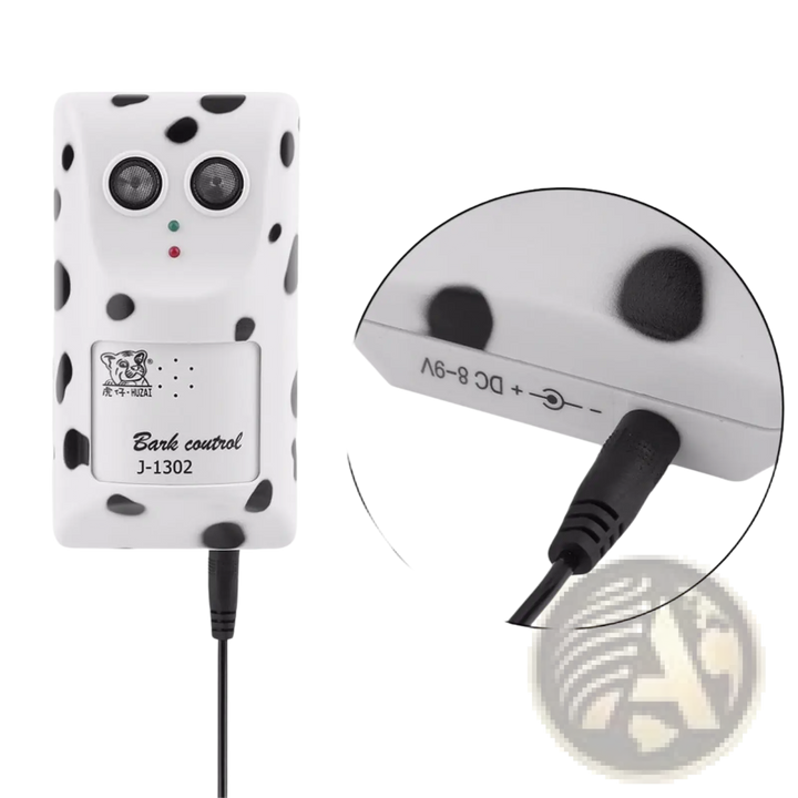 White ultrasonic wall-mount dog bark repellent with power cable and side port detail