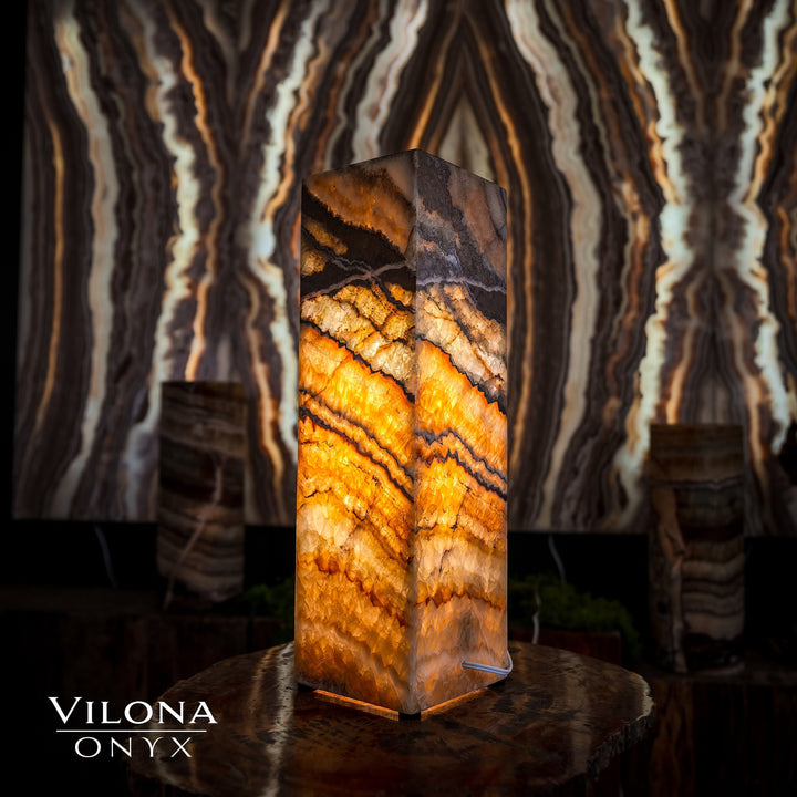 Small square table lamp with amber onyx stone panels and dark top corner detail