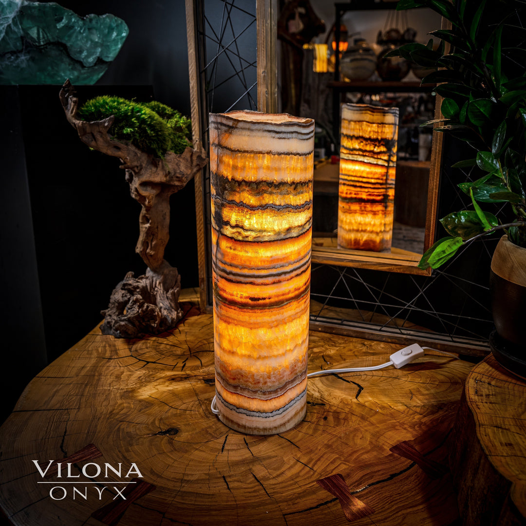 Onyx table lamp with tall cylindrical shade, glowing amber banded onyx finish