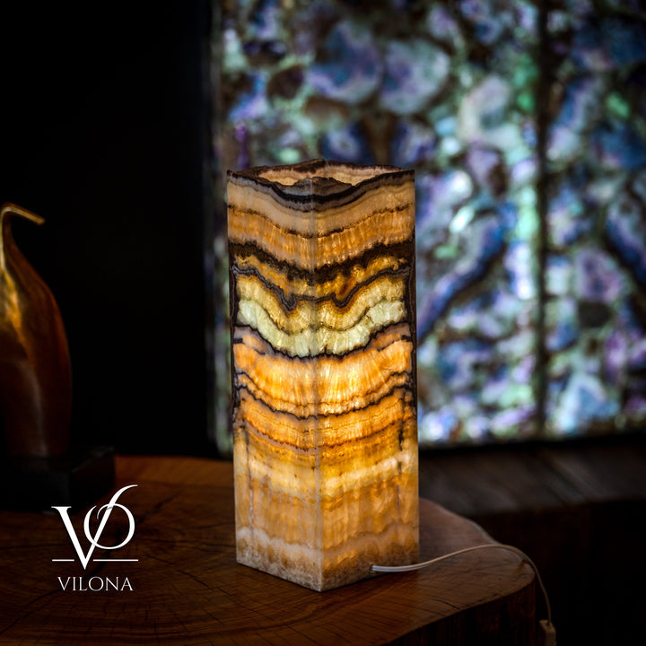 Small square onyx table lamp with golden-russet striations and dark banding, live-edge top