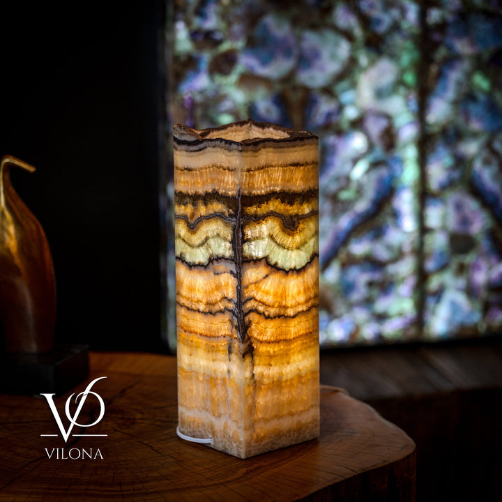 Small square onyx table lamp with bright golden bands and dark streaks, live-edge top