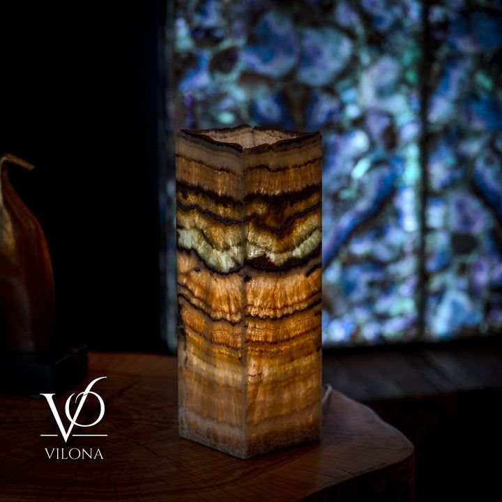 Small table lamp with square live-edge wood base, golden amber stripes with dark accents