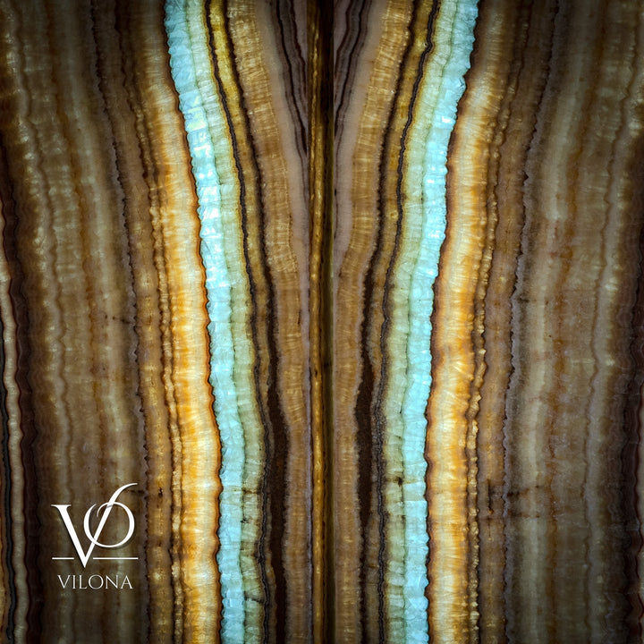 Close-up of two onyx-style wall panels with bright aqua and amber vertical bands