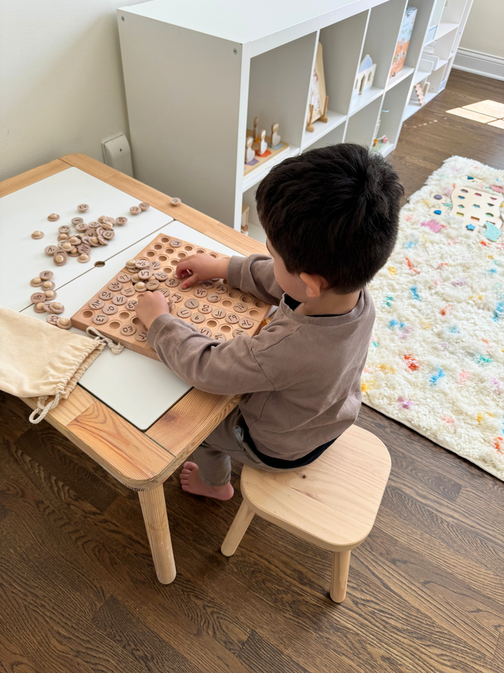 Montessori hundred board learning set with wooden tray, small tokens, and pouches