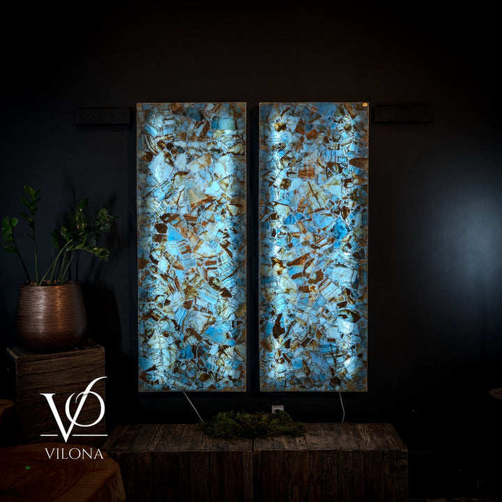 Backlit blue onyx mosaic wall panels in a split pair with vivid stone texture