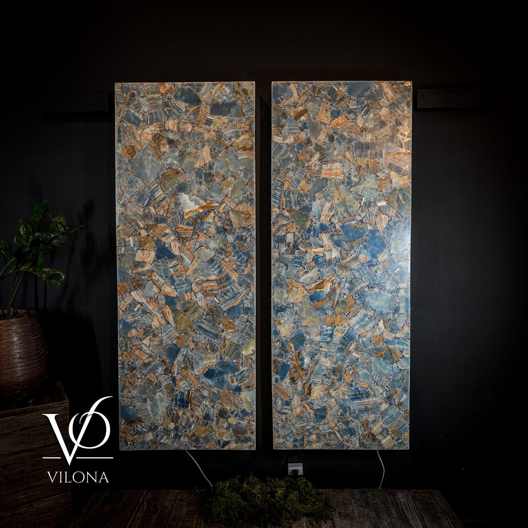 Backlit mosaic wall panels with blue and orange stone pieces in a split pair
