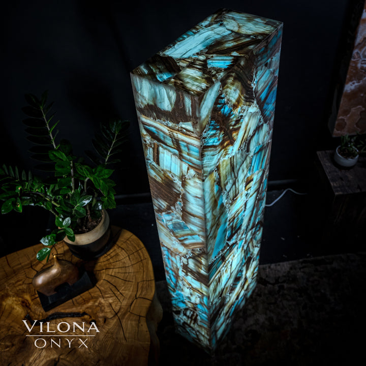 Angled view of rectangular blue onyx floor lamp with teal highlights and dark veining.