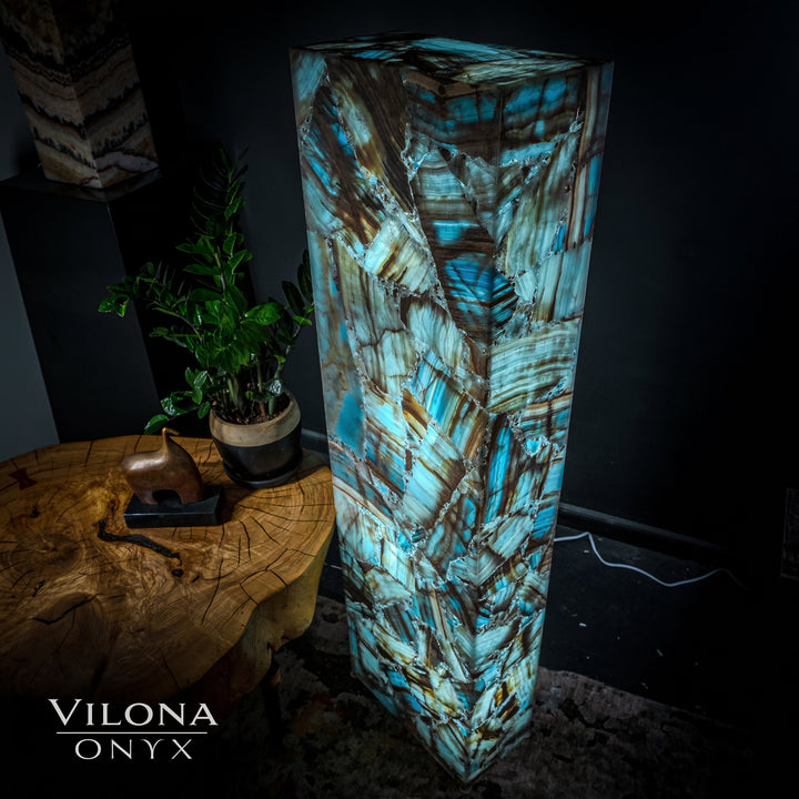 Rectangular blue onyx floor lamp with glowing teal veining and geometric stone patterns.
