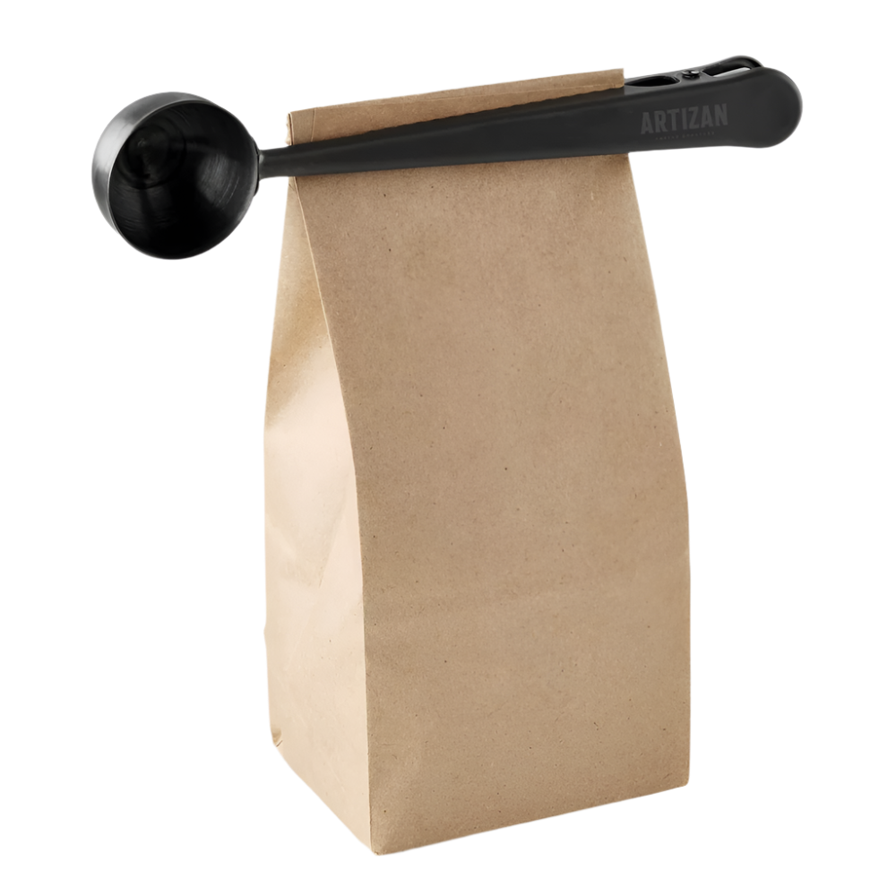 Coffee scoop with bag clip, black scoop beside kraft paper coffee bag
