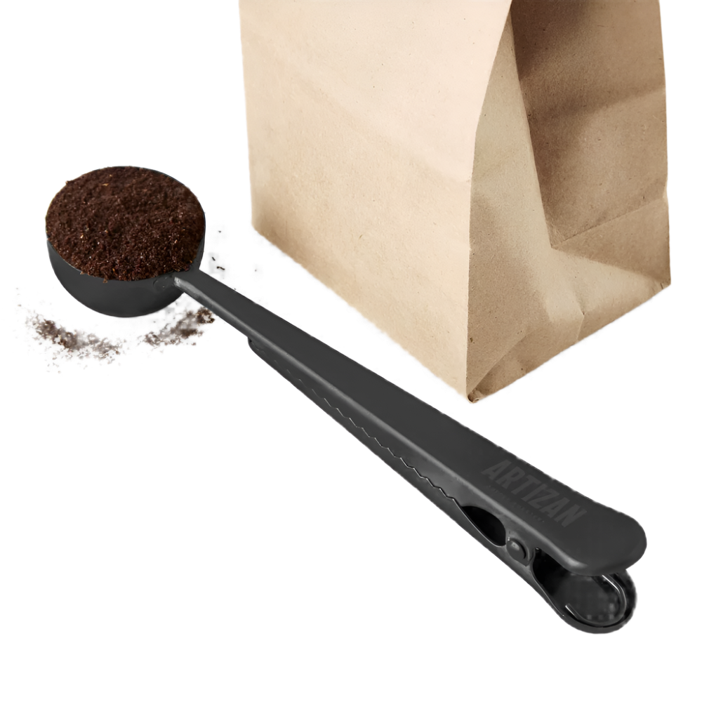 Coffee scoop with bag clip, black scoop next to open kraft paper coffee bag