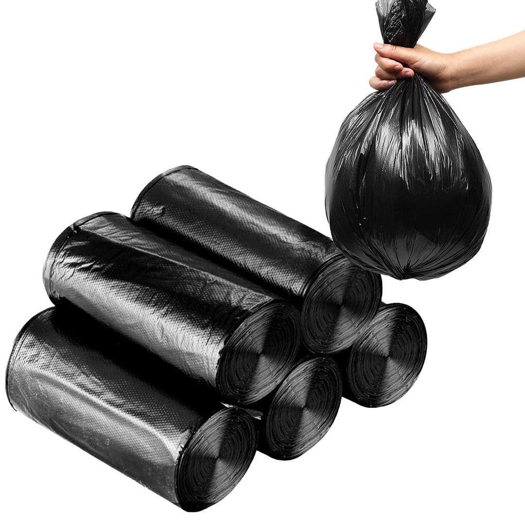 Black garbage bag rolls, hand holding a tied liner bundle