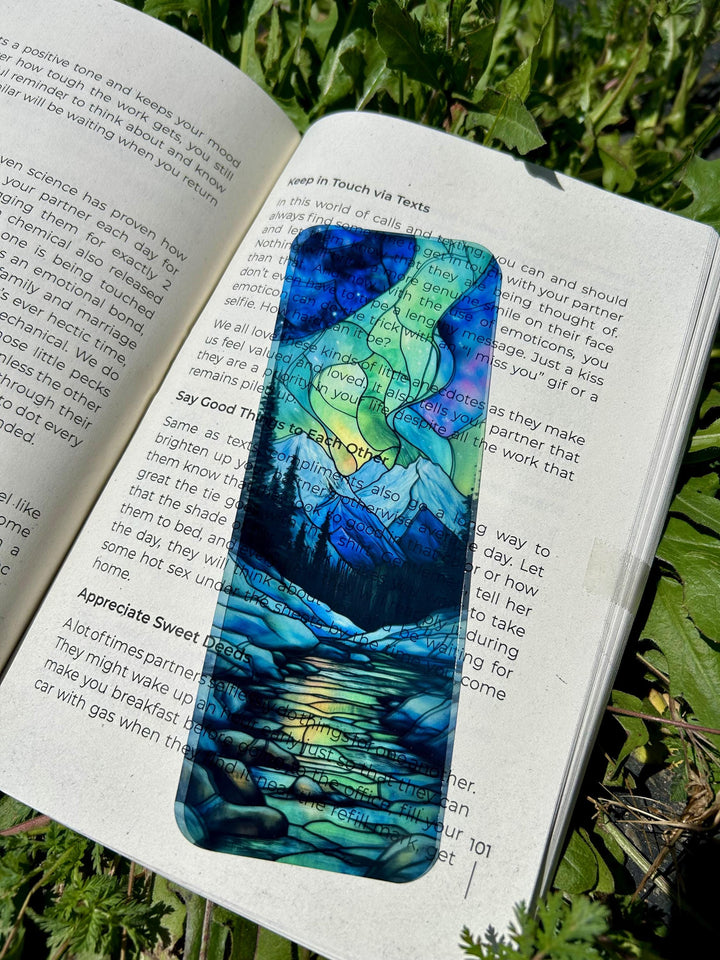 Handmade aurora bookmark with blue, teal, and green stained-glass art on paper