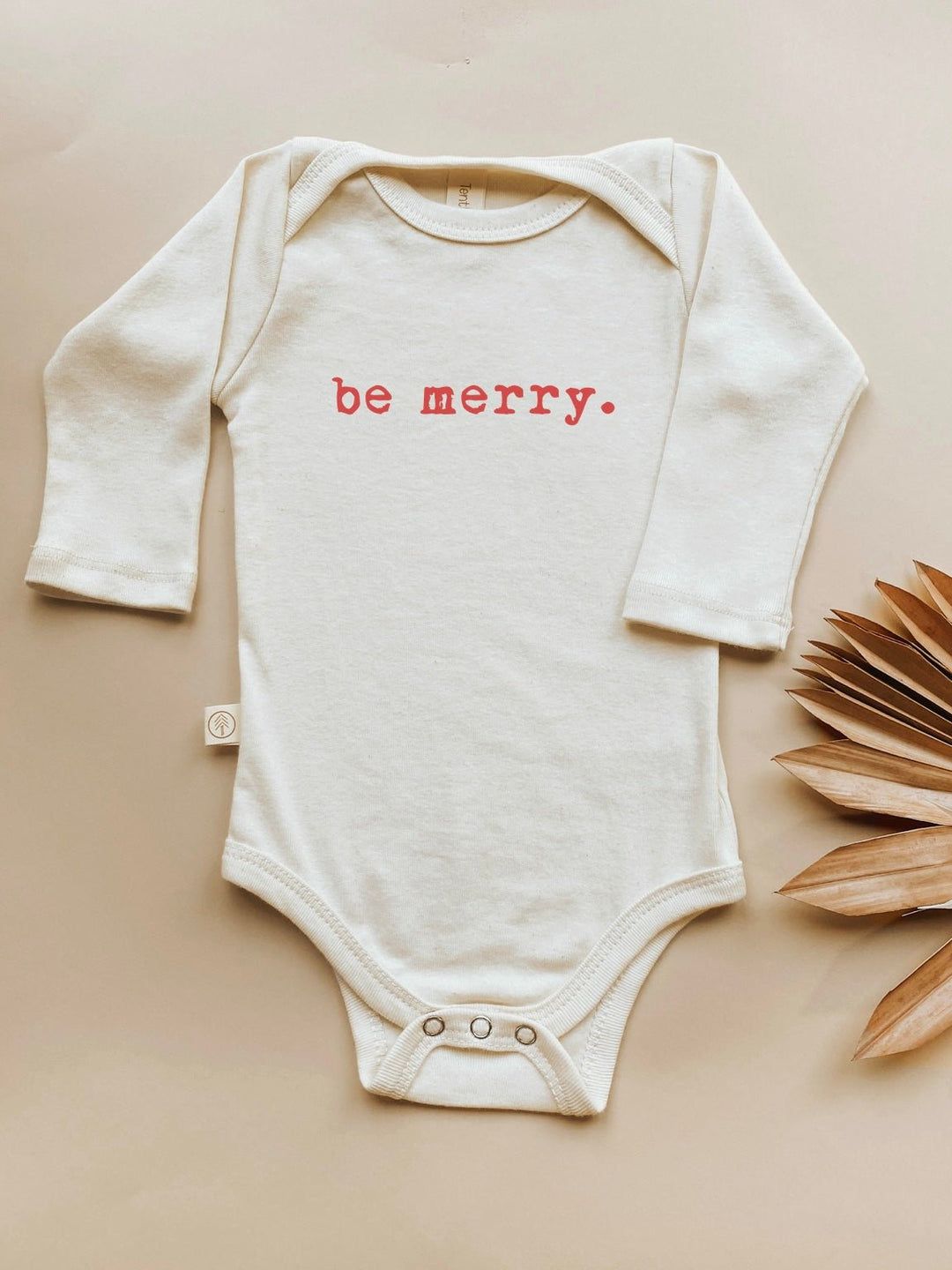 Long-sleeve baby bodysuit in cream with red "be merry" front print