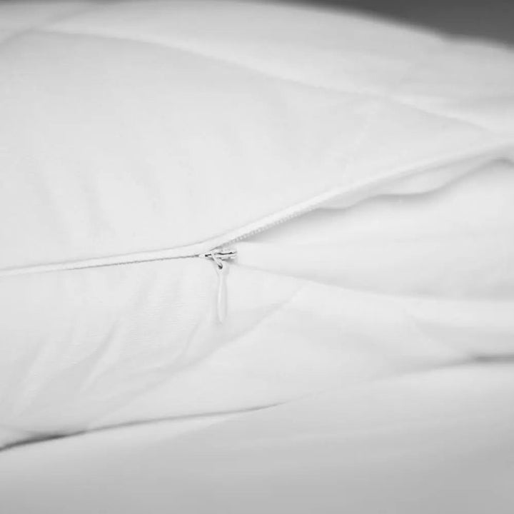 Bamboo pillow protector with visible zipper closure along the edge