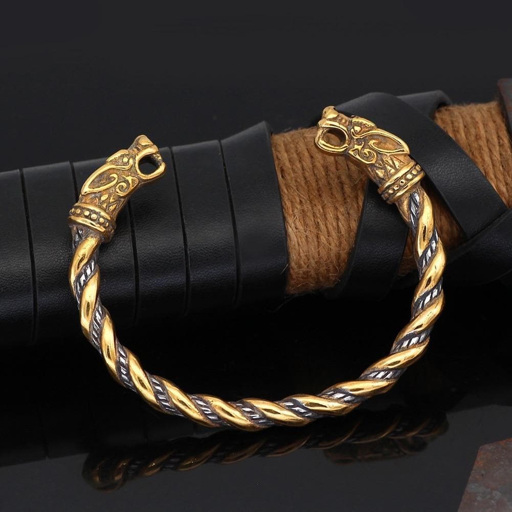 Braided gold-tone bracelet with engraved wolf-head end caps