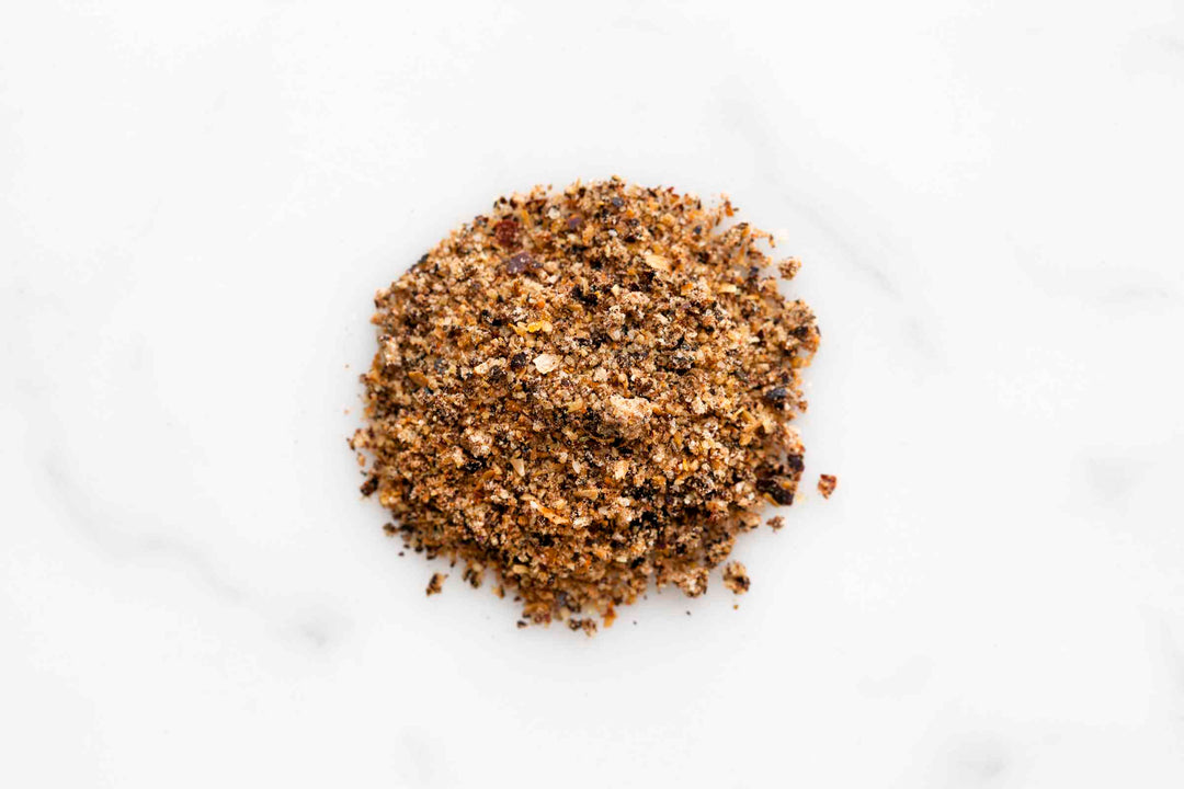 Ground beef rub seasoning pile on a white surface