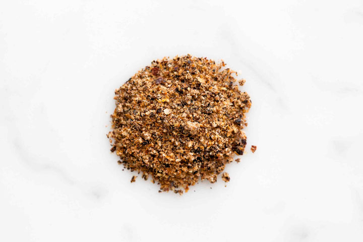 Ground beef rub seasoning pile on a white surface