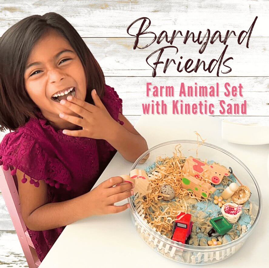 Child playing with farm animal kinetic sand set in clear round tray