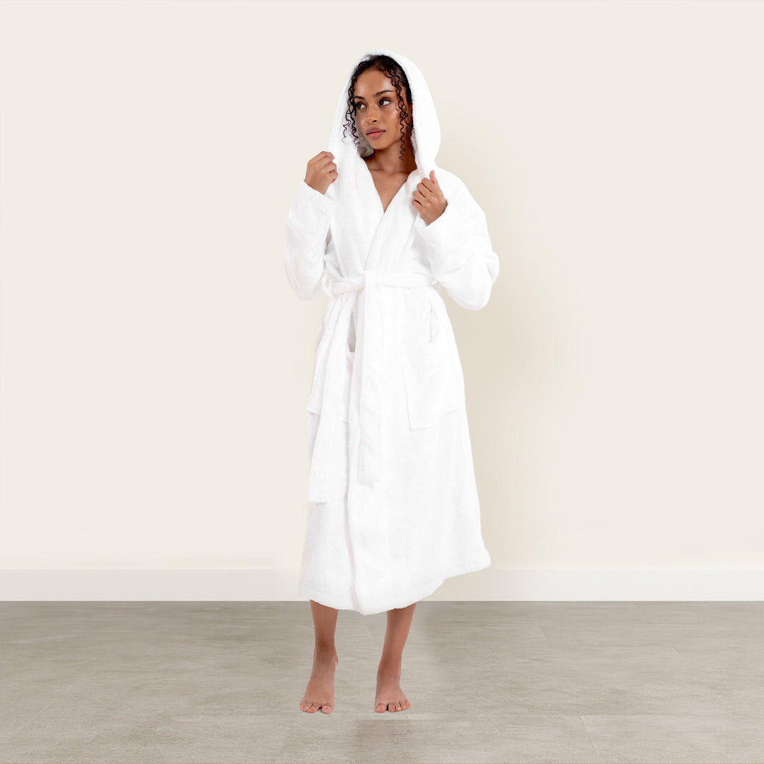 Solid white hooded unisex bathrobe with tie belt, knee-length terry, long sleeves