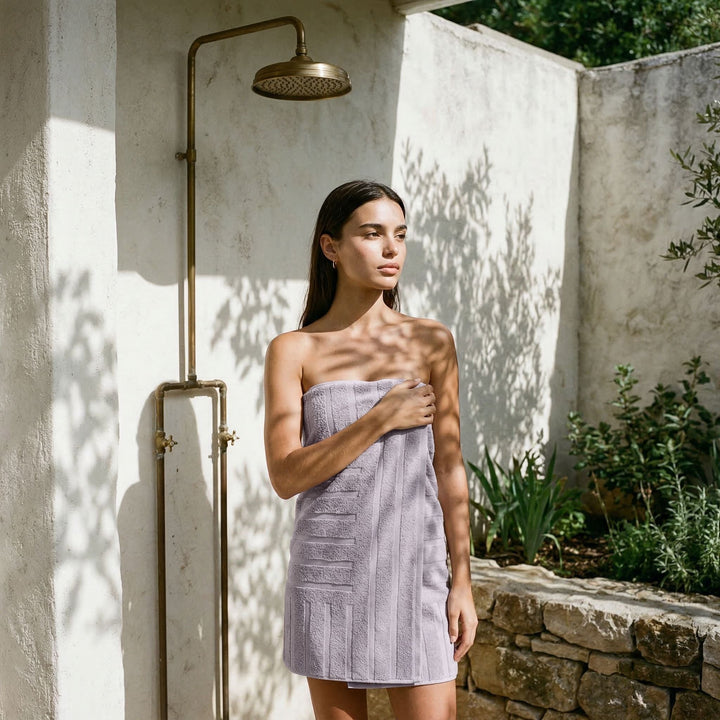 Cotton towel in light lavender with textured vertical stripe pattern, worn as a short wrap.