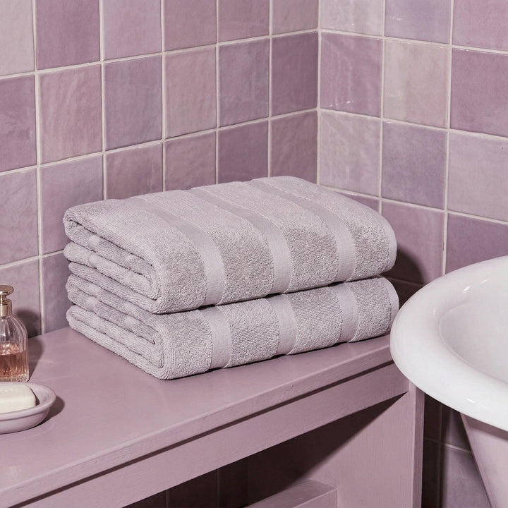 Lilac cotton towel set, two folded bath towels with horizontal stripe bands