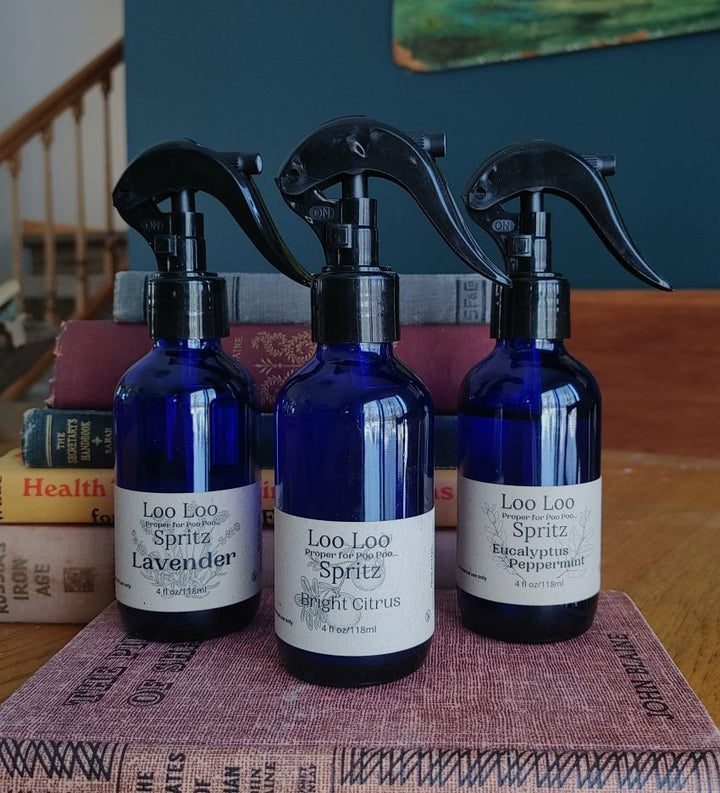 Deodorizing bathroom spray set of 3 blue bottles with black trigger, assorted scent labels.