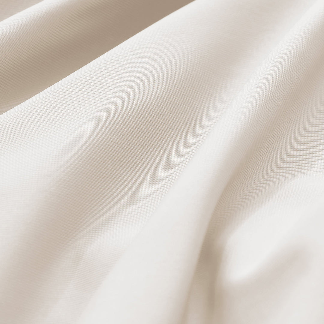 Cream-beige cooling pillowcase fabric close-up, fine breathable weave texture